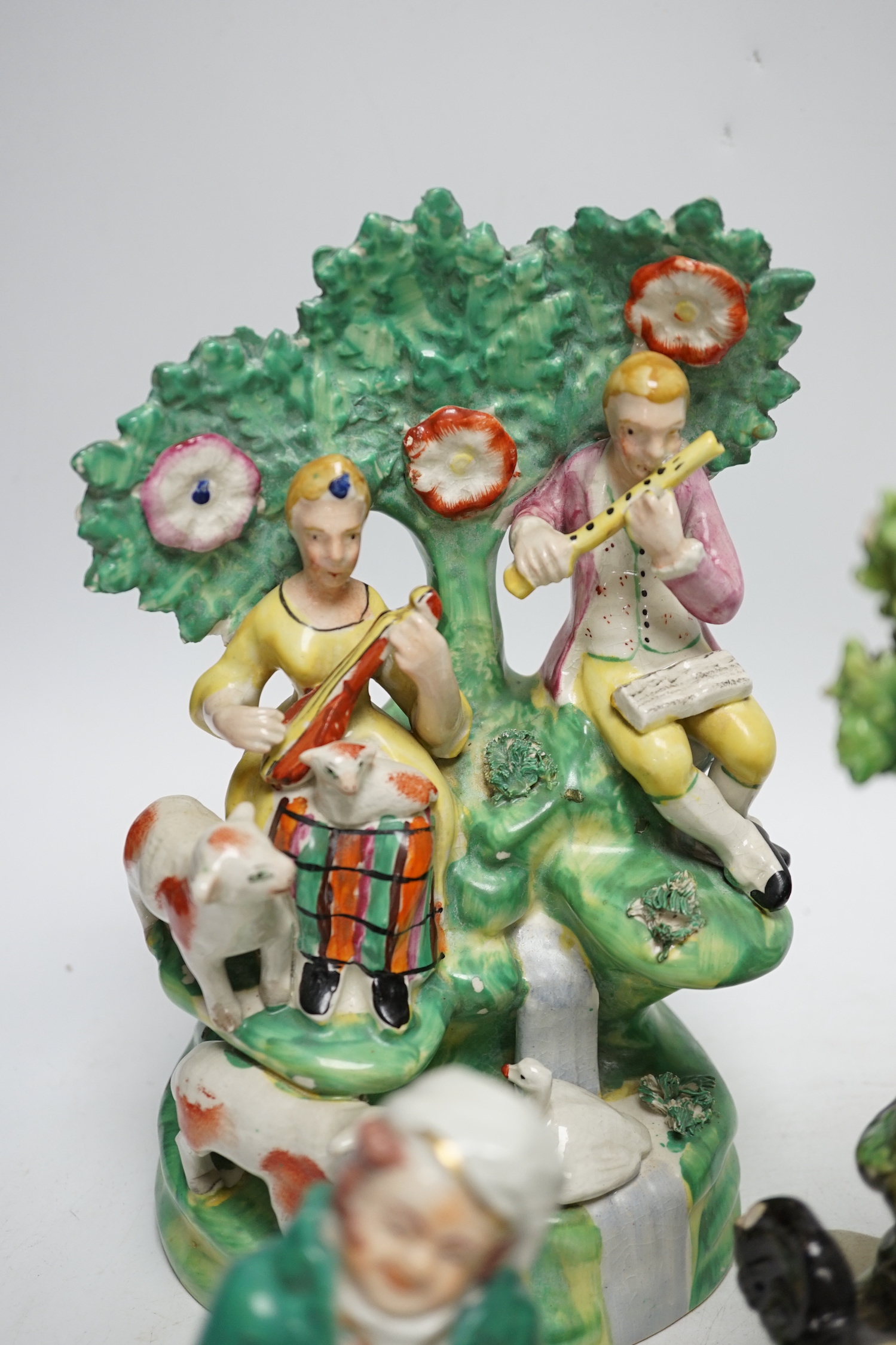 A Staffordshire pottery group of two figures with chickens, c.1800-10, a pair of early 20th century Staffordshire pottery figure groups and three small character figures, tallest 25cm high (6)
